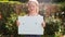 Teenage girl holding up a blank card