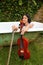 Teenage girl holding violin and fiddlestick outdoor in bathtub