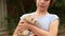 a teenage girl holds a domestic ferret in her hands on a walk. unusual pets.