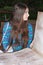 A teenage girl holds a huge antique book