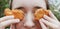 A teenage girl holds nuggets near her eyes