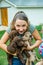 Teenage girl holds and snuggles with new labradoodle puppies