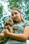 Teenage girl holds and snuggles with new labradoodle puppies