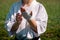 Teenage girl in a kimono wrapping a wrist wrap around her hand before taking karate outdoors