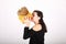 Teenage girl kissing pumpkin in yellow cap with bobbles