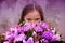 Teenage girl with large bunch of colorful flowers