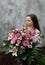 Teenage girl with large bunch of flowers