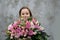 Teenage girl with large bunch of flowers