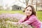 Teenage girl laying flower field barn background