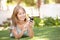 Teenage Girl Laying In Park Using Mobile Phone