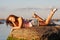 Teenage girl laying on a stone