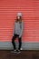 Teenage girl leaning against a shuttered door