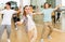 Teenage girl learning to dance lindy hop in pair in choreography class