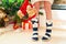 Teenage girl legs in cozy warm woolen socks with pompons