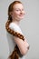 Teenage girl with long red plait