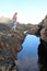 Teenage girl looks at water in Garachico, Spain