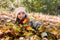 Teenage girl lying and playing in the leaves, happy.