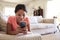 Teenage girl lying on the sofa at home in the living room using smartphone, close up, low angle, close up