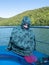 Teenage girl making fun of the cold on a lake boat
