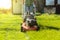 Teenage girl mowing grass