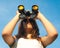 Teenage girl observing with binoculars