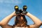 Teenage girl observing nature with binoculars