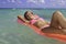 Teenage girl in pink bikini floating