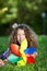 Teenage Girl With Pinwheel Lying On Grass