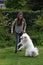 Teenage girl plays with a young  samoyed