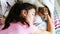 Teenage girl with ponytail and small puppy sleep on blanket