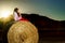 Teenage girl posing at the evening on haystack, sunset colors