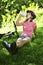 Teenage girl resting in a park with a bicycle