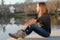 Teenage girl resting on river bank