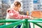 A teenage girl rides a carousel in a playground in the yard