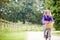 Teenage Girl Riding Bike Along Country Lane