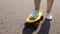 Teenage girl right foot on short modern skateboard