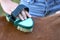 Teenage girl`s hand brushing a back of pony horse on close up