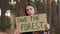 Teenage girl with Save the Forest poster