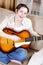 Teenage girl singing by guitar