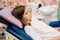 a teenage girl sits in a chair in a dental office. regular preventive visits