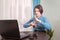 A teenage girl sits in front of her laptop learning sign language, a language for the deaf and dumb online