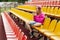 A teenage girl sits on the school bleachers and writes a message on her phone in her free time