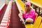 A teenage girl sits on the school bleachers and writes a message on her phone in her free time