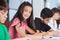 Teenage Girl Sitting With Classmates Studying At