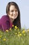 Teenage Girl Sitting In Summer Meadow