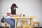 A teenage girl sitting type messages on mobile phones.