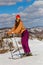 Teenage girl skis in the mountains