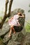 Teenage girl sleeping on rock above river