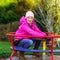 Teenage girl on small roundabout