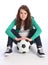Teenage girl soccer player sits with football